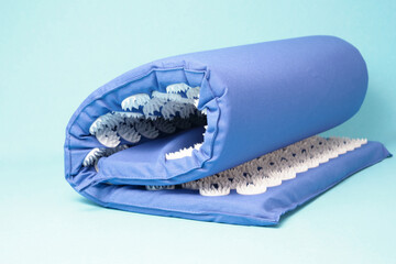 acupuncture massage mat on blue background isolated