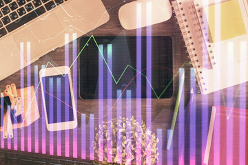 Double exposure of forex chart hologram over desktop with phone. Top view. Mobile trade platform concept.