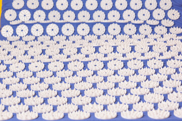 blue massage acupuncture mat with white massage tips, massage mat for relaxation and treatment