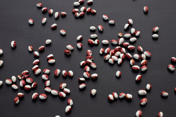 lot of beans are scattered on a black background