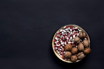 Creative mockup bowl with beans and nuts on black background