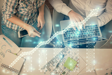 Fototapeta premium Multi exposure of man and woman working together and forex graph hologram drawing. Financial analysis concept. Computer background. Top View.