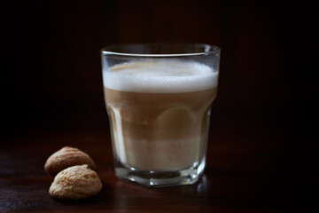 Coffee with milk on dark wooden background. Close up.