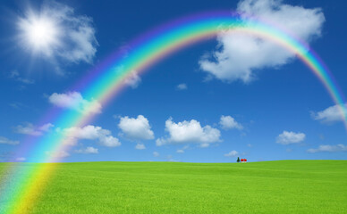 草原の赤い屋根の家と雲と虹と太陽