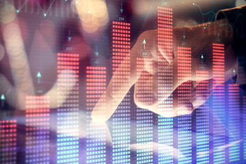 Multi exposure of man's hands holding and using a phone and financial chart drawing. Market analysis concept.