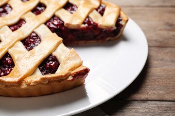 Delicious fresh cherry pie on wooden table, closeup