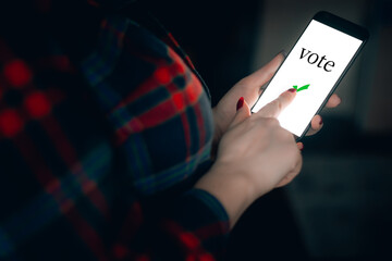 Woman holds phone in her hands. Online voting and elections concept.