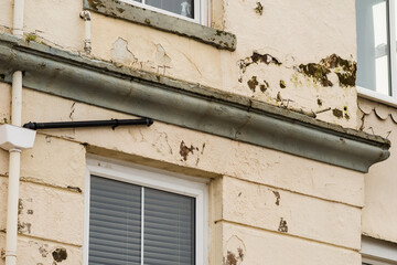 flaking peeling discoloured paint coatings to the exterior of a building