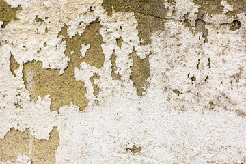 flaking peeling paint coatings to an exterior cement rendered wall.