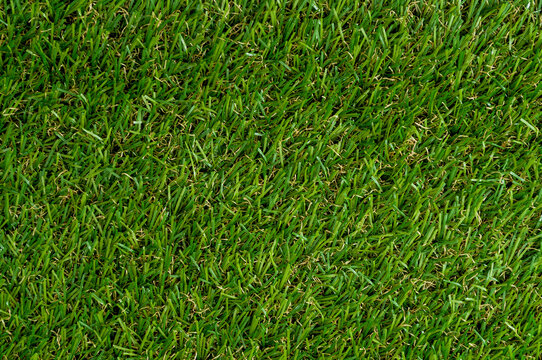 Sport wallpaper and football or soccer stadium concept with top view full frame image of green grass background wit copy space