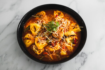 plant-based food, vegan eggplant tortellini with tomato sauce and dairy-free parmesan