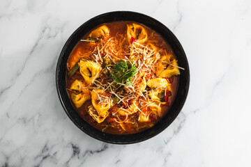 plant-based food, vegan eggplant tortellini with tomato sauce and dairy-free parmesan