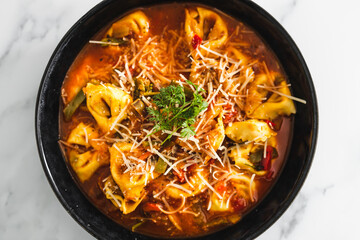 plant-based food, vegan eggplant tortellini with tomato sauce and dairy-free parmesan