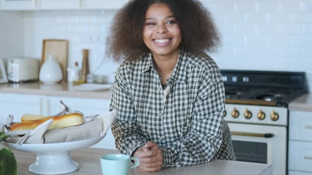 portrait of smiling black woman in kitchen