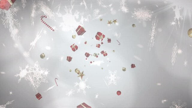 Christmas presents, candy canes and baubles against snowflakes falling on grey background