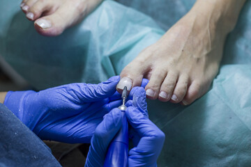 Close up of doctor in gloves making procedure for foot. Pedicure in beauty spa salon. Beautician...