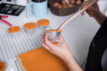 Woman during making decorating cooking bakery cake at homemade