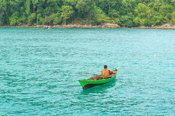 fishermen with wooden boats on the sea