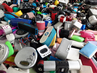 Piles of used electronic and household items are cracked or damaged, Electronic waste is used for reuse and Recycle and is a concern for environmental and waste management.