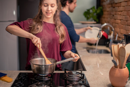 Couple preparing meal and washing dishes