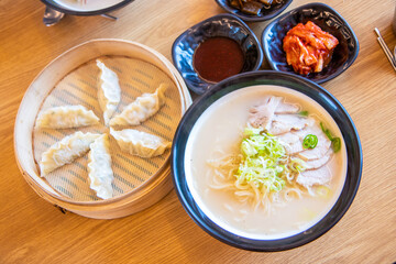 Korean traditional dumplings and soy milk noodle soup, Kong-Guksu served with kimchi and soy sauce