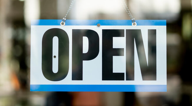 Open Business sign hanging inside store