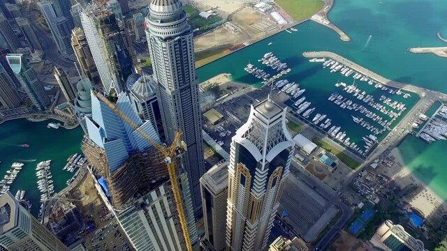 Amazing birds-eye view of the towering skyscraper of Dubai marina as the camera dolly in between building capturing an amazing side of Dubai Marina 6-axis stabilized gimbal, Shotover F1, 8K, parallax