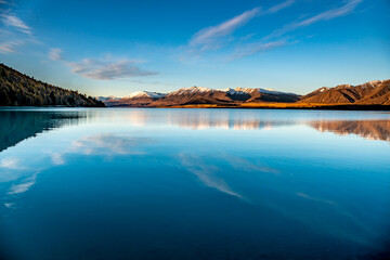 Fototapeta premium The serenity of a deserted beautiful lake Takapo with cloud reflections on the lake surface