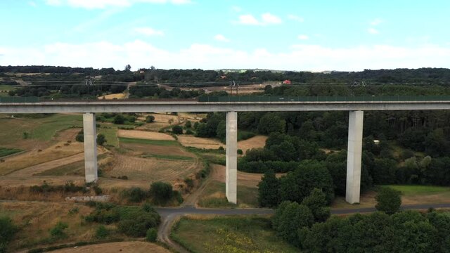 Lush Trees On The Vast Terrain Beneath A Railway Bridge In Botos, Galicia, Spain - aerial drone, tracking shot
