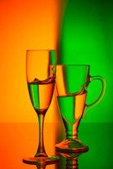Still life with glass objects on a colored background