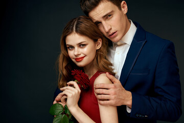 luxury couple hug romance relationship rose over dark isolated background