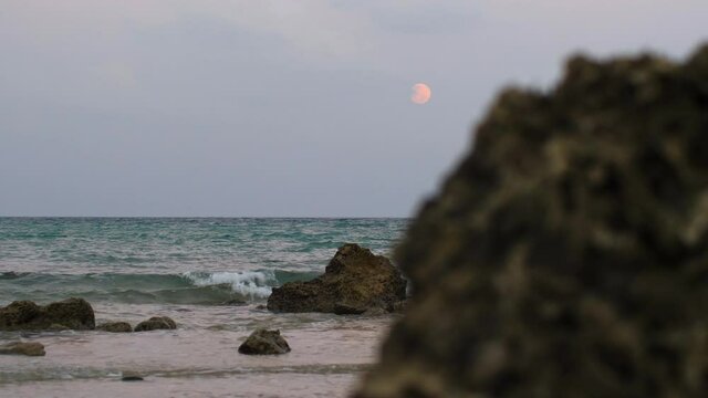 red blood moon rise up over indian beach in andaman islands, slowmo
