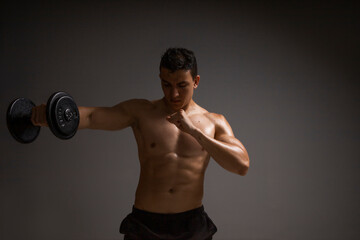 Fototapeta na wymiar man doing arm exercises with dumbbells, sport concept