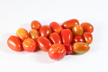 Fresh ripe small shiny red tomato on white background