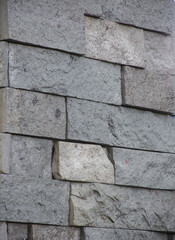 Vertical wall of bricks in cold tones