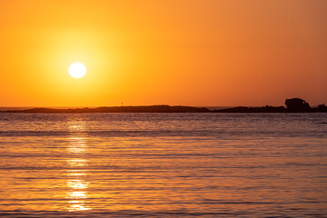 Sunset over Pacific Ocean viewed from Sunset Bay, Oregon Coast.