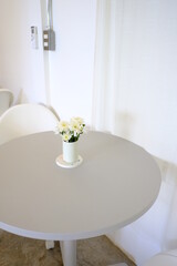White flowers in vase on table with White background. floral arrangement, copy space