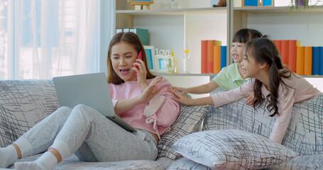 Young mother raise hand forbid two daughter teases her