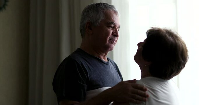 Senior husband caring for wife, loving maried couple relationship