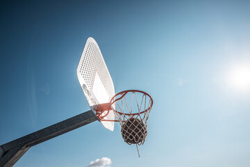basketball an outdoor court on the street.