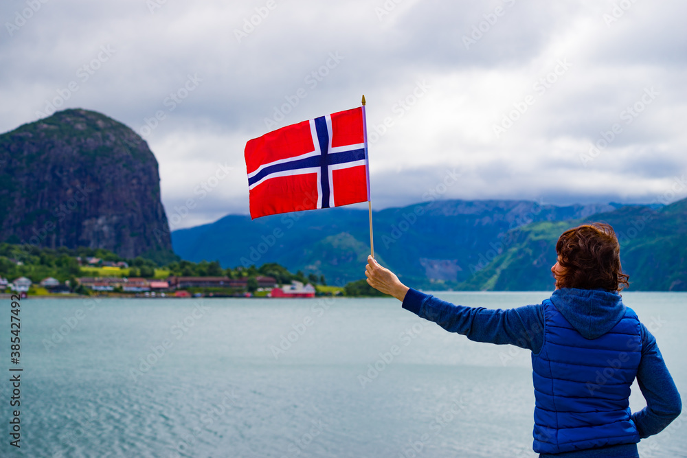 Poster tourist with norwegian flag on fjord