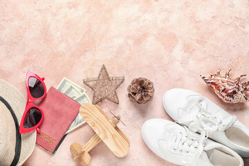 Composition with Christmas decor, passport and beach accessories on color background