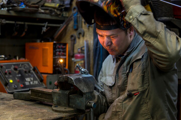 Fototapeta na wymiar Close-up portrait of a welder in the workplace