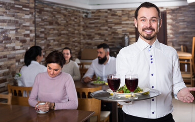 Fototapeta na wymiar Portrait of adults guest in middle class restaurant and waiter