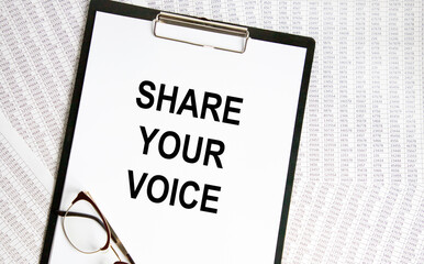 Paper plate, glasses, notepad,pen and pencils on the white background. Business concept. Text SHARE YOUR VOICE