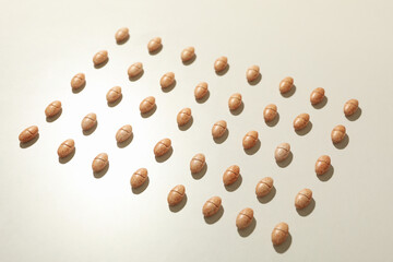 Square made of pills on gray background