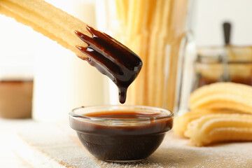 Concept of sweet lunch with churros on white wooden background