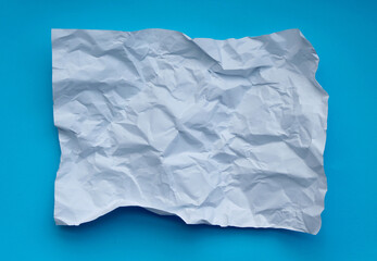 Crumpled paper  isolated on blue background .