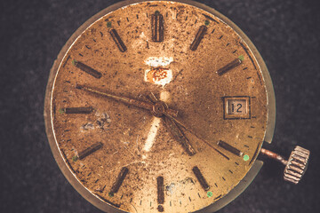 Obraz na płótnie Canvas Vintage wall clock on a dark background. Selective focus. Vintage light toning. Grunge style backdrop