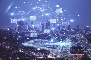Double exposure of envelop hologram flying from gadget and city view background. Concept e-mail.